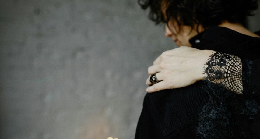 Person Giving Comfort To A Mourning Woman
