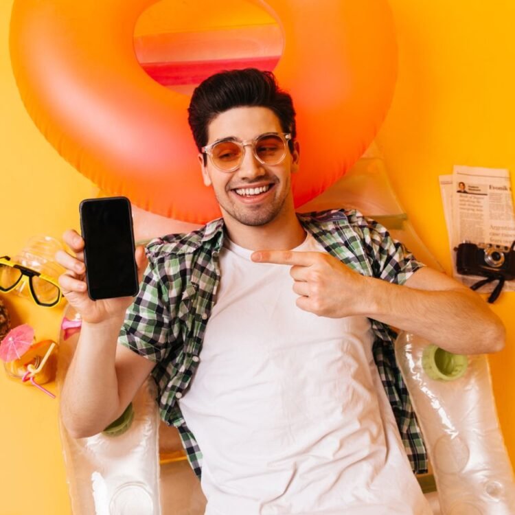 Man in plaid shirt and orange glasses Image by lookstudio on Freepik